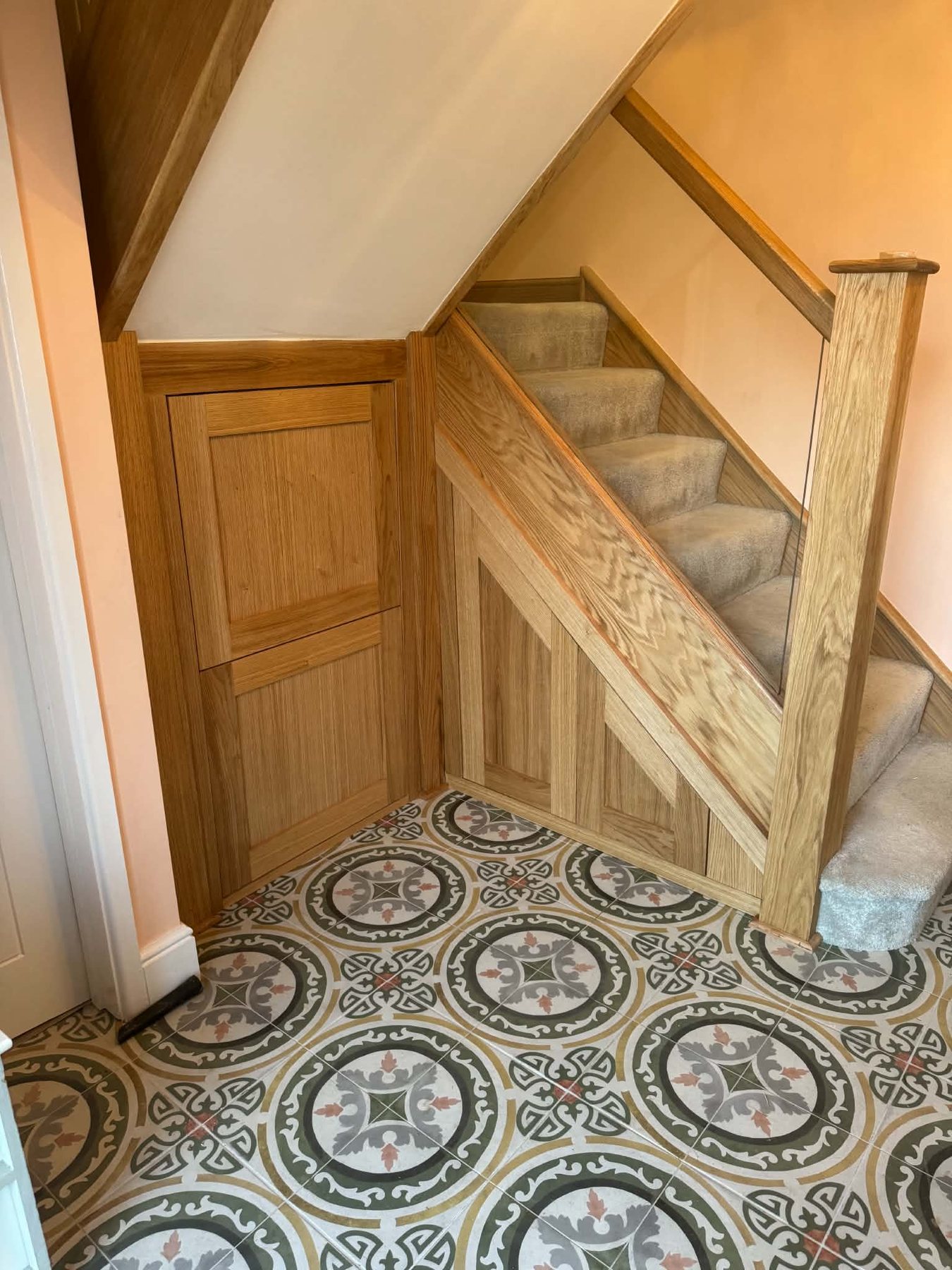 Understairs storage with oak panel door