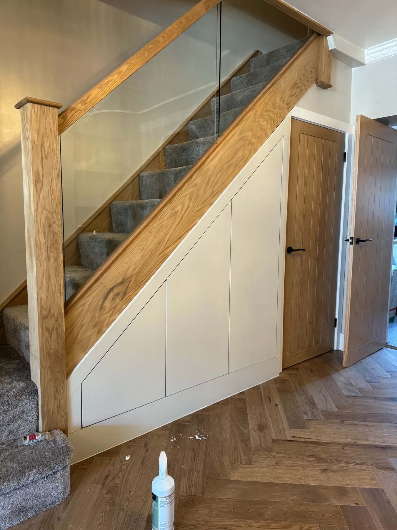 Understairs storage with metal spindles above